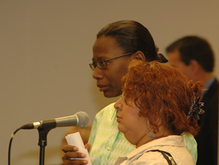 Above photo, September 26, 2007: Rosita DeLaRosa of the Logan Square Neighborhood Association, long a partners with the Chicago Board of Education in local projects, asked the Board of request that the boundaries of two northwest side police districts be changed so that there was no longer confusion about calls regarding gang violence at Funston Elementary School at Armitage and Central Park. According to DeLaRosa, because Central Park Ave. is both the boundary between two Chicago Police districts and the boundary between two major street gangs, police calls about violence at Funston often result in confusing responses, and the gangs seem to be aware of this. With DeLaRosa, in tears, was the mother of a child who was recently murdered when a gang bullet found her as she walked across the school yard. Substance photo by George N. Schmidt. 